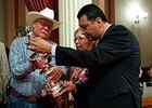 Sen. Alex Padilla (D-Van Nuys) admires the Woodlawn Vase with Steve and Carolyn Coburn.