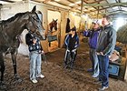 Ron Paolucci, foreground, and trainer Jeremiah Englehart at Fair Grounds watching Ria Antonia work and at the barn.