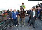 Palace Malice being led into the winner's circle by Cot Campbell.