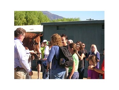 Shackleford (with trainer Dale Romans, left) greets his fans at Santa Anita.