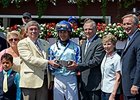 Ralph Evans, on the right holding trophy, following Upstart's win in the Funny Cide Stakes.