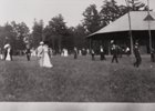 Crowds in paddock at Saratoga Race Course watch the horses as they prepare for their race.