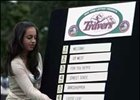 New York Racing Association's Lisa Fiorillo hangs the names of horses during the Travers Stakes post position draw.