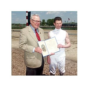 Pennsylvania Racing Commission chairman F. Eugene Dixon, left, presents Stewart Elliott with the Proclamation that Saturday, May 1, 2004 is Smarty Jones Day at both Philadelphia Park and Penn National.
