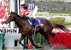 Espoir City, with jockey Tetsuzo Sato, crosses the finish line to win the Japan Cup Dirt at Hanshin Race Course in Japan.