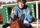 Gran Estreno and Anna Napravnik celebrate the win in the Colonel E. R. Bradley Handicap.