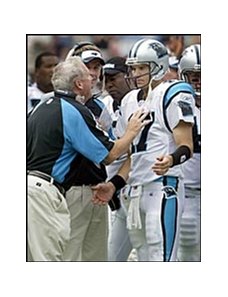 Carolina Panthers quarterback Jake Delhomme, right, talking to coach John Fox.