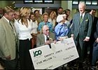 Roy and Pat Chapman, center, hold enlarged copy of a $5 million bonus check given them by Oaklawn Park owner Charles Cella, far right, while trainer John Servis and his wife, Sherry, far left, look on.