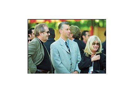 Trainer Todd Pletcher is flanked by Stuart and Anne Subotnick.