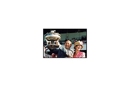 Sarava's owner Gary Drake, holding Belmont trophy, with wife, Kitty.