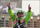 Jockey Calvin Borel celebrates aboard Seek Gold after a last-to-first come-from-behind win in the Stephen Foster.