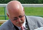 On call veterinarian Larry Bramlage looks over horses on Kentucky Oaks Day.