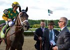 Cot Campbell leads Palace Malice into the winner's circle after the 2013 Belmont Stakes