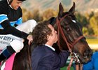 Co-owner Jim Rome gives Shared Belief a kiss after his win in the 2014 Malibu Stakes (gr. I) at Santa Anita Park