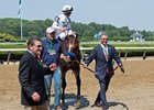 WinStar Farm's Kenny Troutt leads American Anthem into the Belmont Park winner's circle