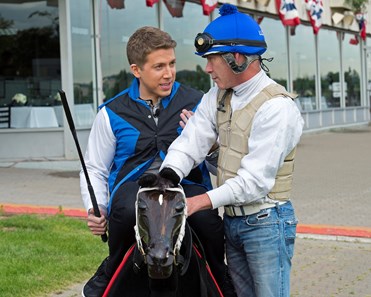 Baruch Shemtov with Good Day New York and Fox News tries out the equicizer equipment for jockeys during segment on jockeys with Mike Luzzi (right)