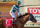 Jockey Victor Espinoza celebrates after his victory aboard Accelerate in the San Diego Handicap