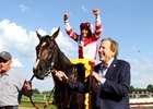 Rick Porter leads Songbird and Mike Smith into the Delaware Park winner's circle