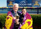 Frank Stronach and jockey Luis Contreras celebrate Holy Helena's Queen's Plate win in the winner's circle July 2 at Woodbine.