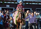 Gun Runner wears the garland of flowers he earned in the Whitney Stakes