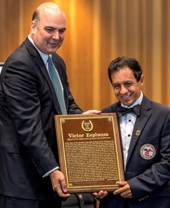 NYRA senior vice president Martin Panza helps jockey Victor Espinoza with his Hall of Fame Plaque at the National Museum of Racing and Hall of Fame induction ceremony held Aug. 4, 2017 at the Fasig Tipton auditorium in Saratoga Springs, N.Y.