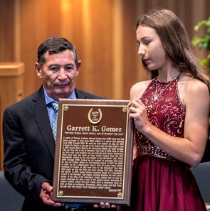 Louie Gomez, father of the late jockey Garrett Gomez holds the Hall of Fame Plaque with his grand daughter Amanda Gomez at the National Museum of Racing and Hall of Fame induction ceremony held Aug. 4, 2017 at the Fasig Tipton auditorium in Saratoga Springs, N.Y.