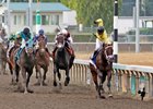Jockey Evin Roman celebrates aboard Gold Rush Dancer after their win in the Longacres Mile
