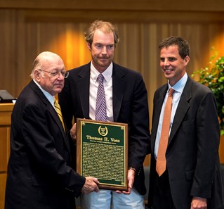 Edward Bowen presents the Hall of Fame Plaque to Sam Voss, son of Tom Voss with Joe Clancy at the National Museum of Racing and Hall of Fame induction ceremony held Aug. 4, 2017 at the Fasig Tipton auditorium in Saratoga Springs, N.Y.