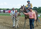 Charles Fipke (left, holding shank) leads Forever Unbridled into the winner's circle as Dallas Stewart (left) looks on
