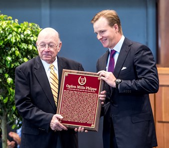 Ogden Phipps II accepts the plaque for his father Dinny Phipps presented by Edward Bowen, left, at the National Museum of Racing and Hall of Fame induction ceremony held Aug. 4, 2017 at the Fasig Tipton auditorium in Saratoga Springs, N.Y.