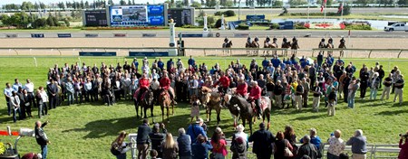 Jockeys, outriders, trainers, owners, grooms and hotwalkers (D.Fortune girlfriend Jockey Aimee Auger holding helmet) join in a moment of silence at Woodbine Racetrack to honor Darren Fortune, who passed after tragic morning accident yesterday at Woodbine.
