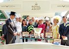 George Bolton (right) and other partners who co-own Lady Aurelia accept the trophy for her King's Stand win from the Duke and Duchess of Cambridge at Royal Ascot