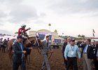 Assistant Scott Blasi (left) and co-owner Ron Winchell (right) lead Gun Runner and Florent Geroux into the winner's circle at Del Mar