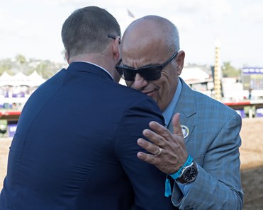 Mark Casse, right, hugging his son, assistant trainer Norm Casse. World Approval wins the Breeders Cup Mile on November 4, 2017