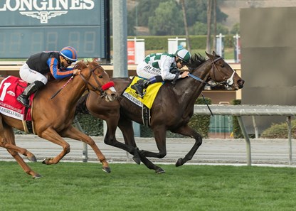Normandy Farm's Daddys Lil Darling and jockey Mike Smith, right, hold off Madam Dancealot (Corey Nakatani), left, to win the G1, $300,000 American Oaks, Saturday, December 30, 2017 at Santa Anita Park, Arcadia CA.