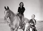 Barbara Stanwyck with her son Dion at the Marwyck Ranch training track in California