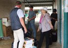 Debby Baltas helps backstretch workers at barn PP in the Del Mar barn area