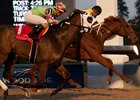 Jockey Eurico Rosa da Silva, aboard Dixie Moon, glances at the fast-approaching Queen's Fate just before the wire in the Ontario Lassie