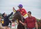 Jockey Florent Geroux aboard Quip celebrates with Rodolphe Brisset after the Tampa Bay Derby