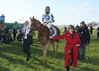 Good Magic with e Five Racing's Bob Edwards (left) and co-owner and breeder Barbara Banke (red jacket) after the Blue Grass Stakes victory at Keeneland