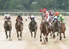 Ricardo Santana Jr. celebrates aboard Unbridled Mo while crossing the finish line of the Apple Blossom Handicap at Oaklawn
