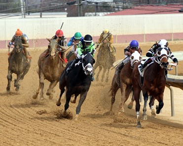 Midnight Poker (#2) with Irad Ortiz Jr. come off the final turn with the lead and win the 7th Running of the Robert Hilton Memorial at Charles Town on April 21, 2018.