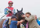 Ultra Brat gets a kiss after winning the Gallorette Stakes at Pimlico Race Course