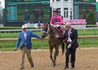 Chris Baccari and Gary Barber walk Salty and Tyler Gaffalione into the winner's circle after their La Troienne victory at Churchill Downs