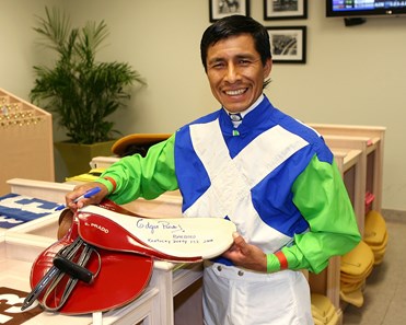 Jockey Edgar Prado holds the saddle that he used to ride Barbaro to victory in the 2006 Kentucky Derby in the Jockeys Room at Gulfstream Park in Hallandale Beach, Florida on Sunday April 1, 2007. Prado signed and is donating the saddle, which he also used to ride the 2002 and 2004 Belmont Stakes winners, for a special auction that will be held at the Mint Jubilee Gala on May 4, 2007 in Louisville, Kentucky, the day before the 2007 Kentucky Derby. Proceeds from the auction will benefit permanently disabled jockeys. .