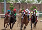 Mia Mischief (white cap) leads the field as they turn for home in the the Eight Belles at Churchill Downs