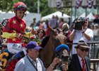 Teo Ah Khing of China Horse Club (right) leads Abel Tasman and Mike Smith into the winner's circle at Belmont Park
