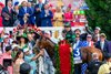 Mystik Dan wears the garland of roses in the Kentucky Derby winners&#39; circle at Churchill Downs