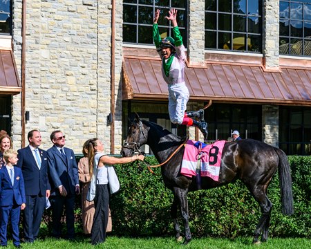 Frankie Dettori makes his famous flying dismount after winning the Woodford Stakes aboard Khaadem at Keeneland