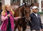 Anna's Co-Owner and breeder, Judy Hicks, and a groom for Kenny McPeek walk Thorpedo Anna in the paddock at Churchill Downs.